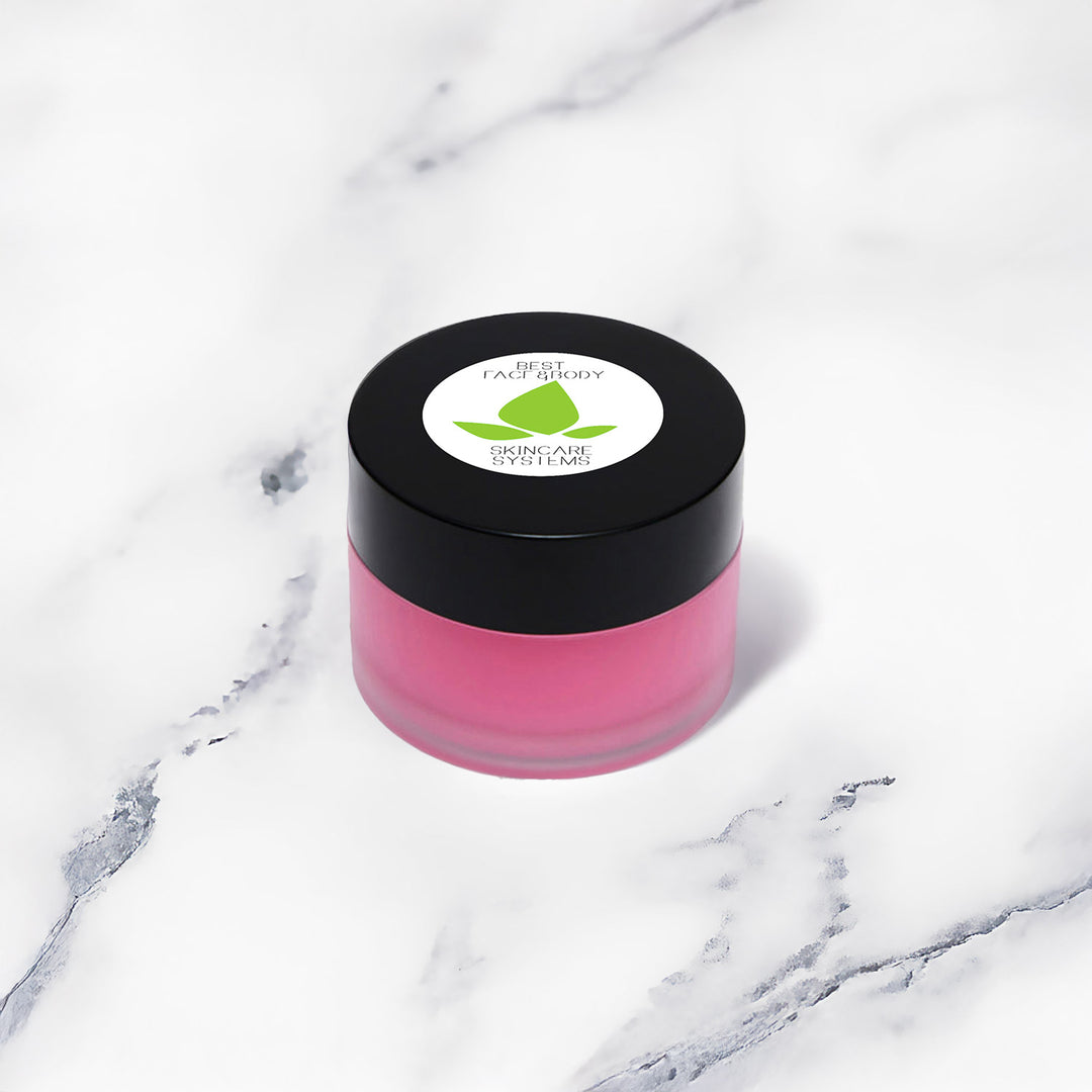 A small cylindrical beauty product shown at an angle on a white marble surface.