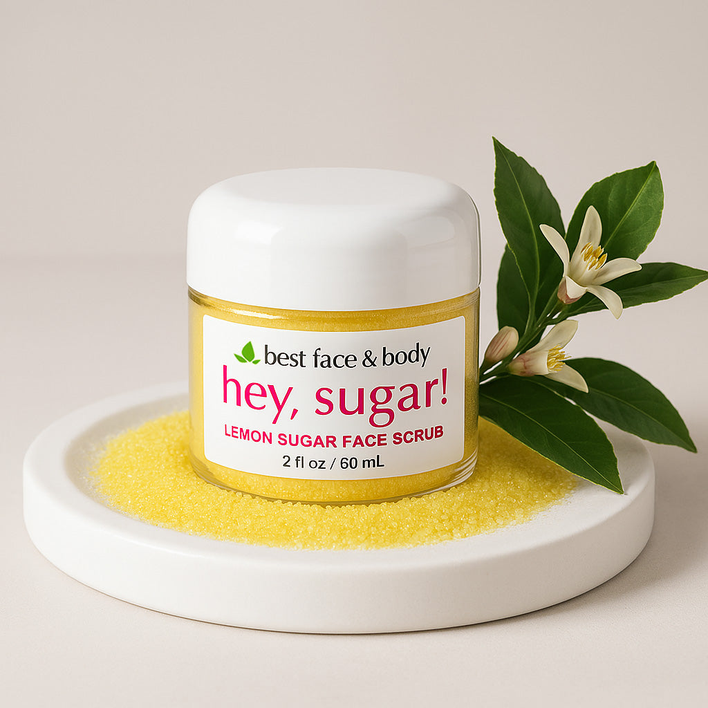 A container of 'Hey, Sugar! Lemon Sugar Face Scrub' by Best Face & Body, surrounded by dried lemon sugar scrubby bits and floral elements.