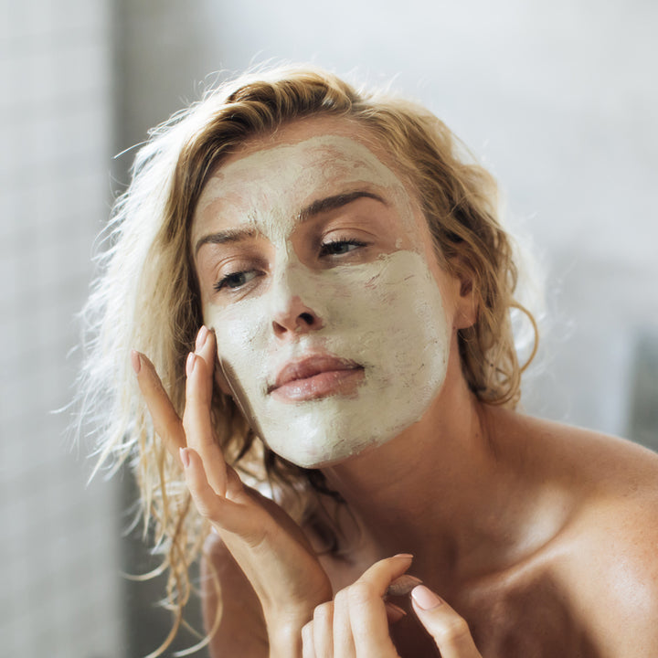 Woman applying face masque