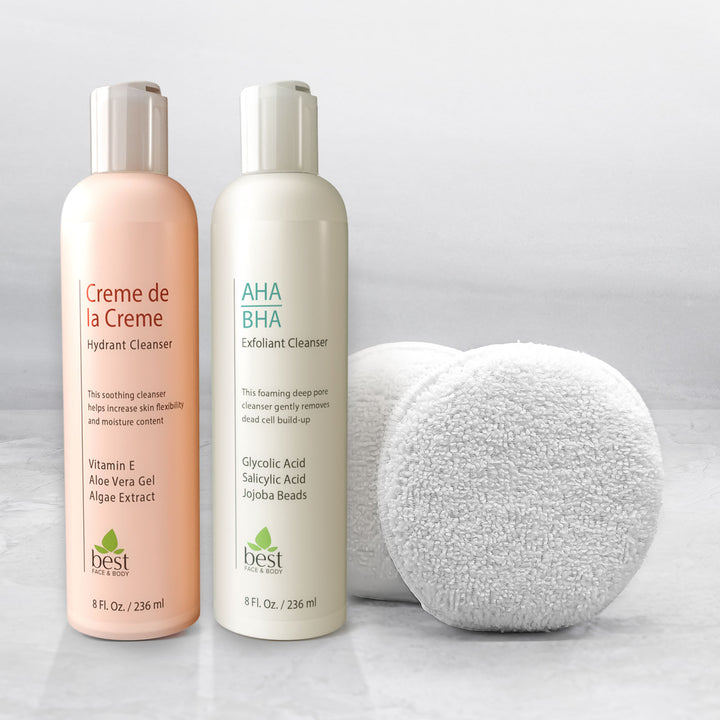 Two bottles of facial cleanser, one labeled 'Creme de la Creme Hydrant Cleanser' and another 'AHA/BHA Exfoliant Cleanser', alongside a set of two terrycloth makeup remover pads.