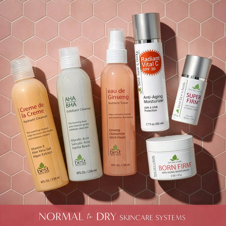 Collection of skincare products for normal to dry skin on a pink hexagonal tile background