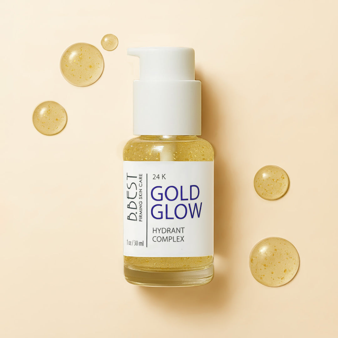 Bottle of 'Gold Glow' hydrant complex with gold droplets on a soft yellow
background