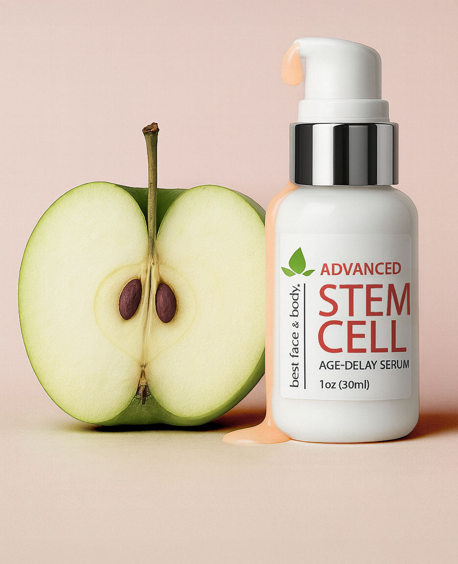Skincare serum bottle labeled 'Advanced Stem Cell' next to a halved green apple on a pink background