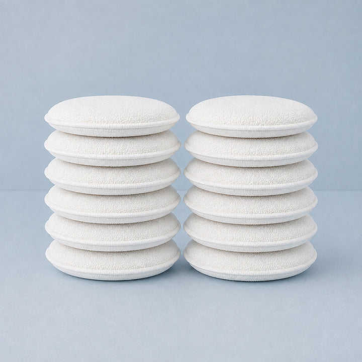 Stacks of white foam bonni pads on a light blue background