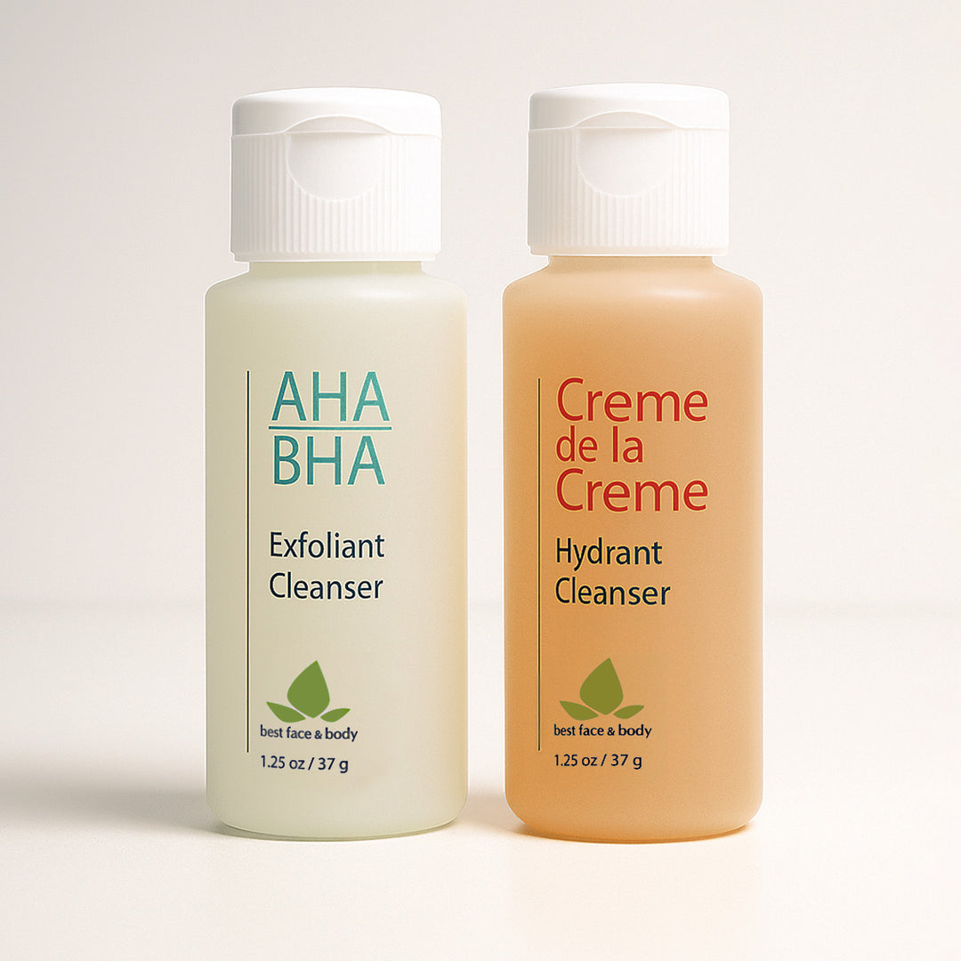 Two travel-sized skincare bottles labeled 'AHA BHA Exfoliant Cleanser' and 'Creme de la Creme Hydrant Cleanser' on a light background.