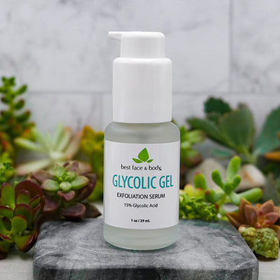 Glycolic Gel Exfoliation Serum 1 oz frosted glass bottle with white pump top, photographed on stone with succulents in background
