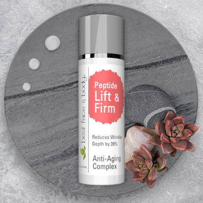 Peptide Lift & Firm Anti-Aging Complex Reduces Wrinkle Depth by 39%. Pictured white cylindrical cosmetic bottle with silver grey cap, situated on a stone surface with rocks and succulent flowers on the side. 